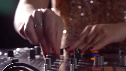 Female DJ hands turning knobs on console close up Stock Footage 139977613