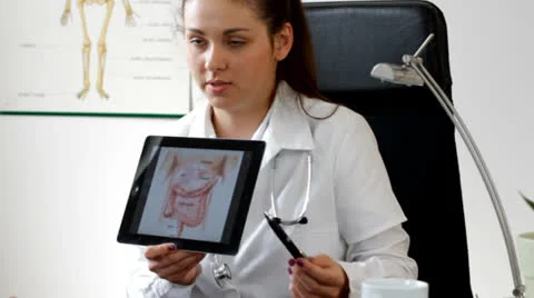 Female doc explaining something in tablet to patient - tracking shot Stock Footage 22935587