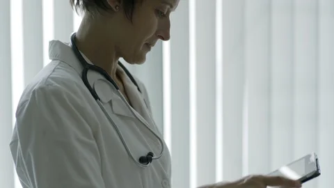 Female doctor browsing tablet computer Stock Footage 103472932