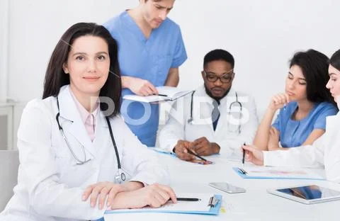 Female doctor at concilium, looking at camera Stock Photos