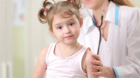 doctor examines child vigania Female pediatrician examines baby with a stethoscope.