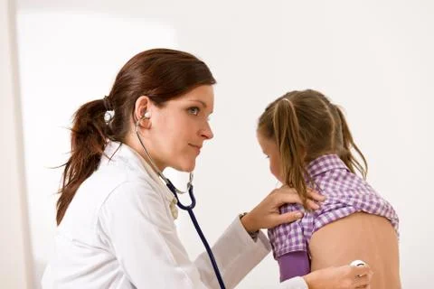 Female doctor examining child with stethoscope Stock Photos