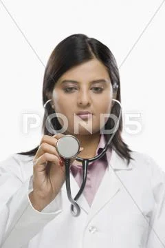 Female doctor examining with a stethoscope Stock Photos