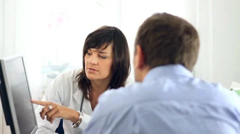 Female doctor explaining something on computer monitor to male patient HD 스톡 동영상 7755693