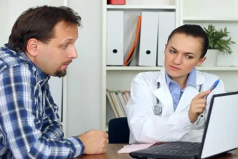 Female doctor explaining something on computer monitor to male patient Stock Footage 8852587