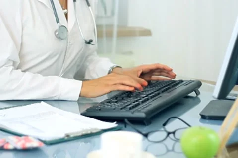 Female doctor hands working on computer NTSC Stock Footage 7755526