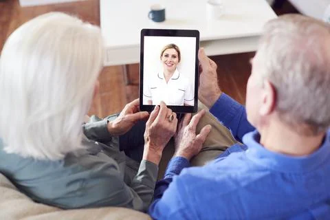 Female Doctor Having Video Consultation With Senior Couple On Digital Tablet At Stock Photos