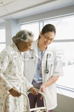 Female doctor helping senior African woman with walker Stock Photos