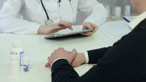 Female doctor inserting patient's data in electronic medical record on tablet pc Stock Footage 87311445