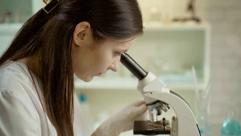 Female Doctor In Laboratory With Microscope Видео 127247275