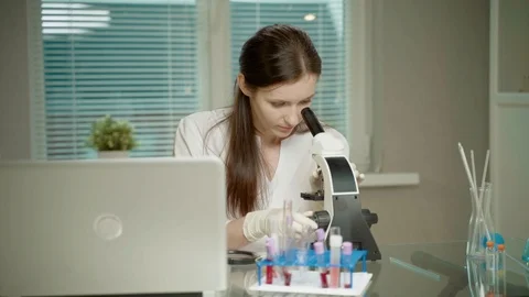 Female Doctor In Laboratory With Microscope Stock Footage 127446213