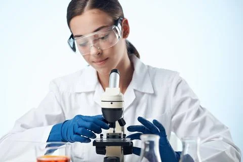 Female doctor laboratory microscope study closeup Foto stock