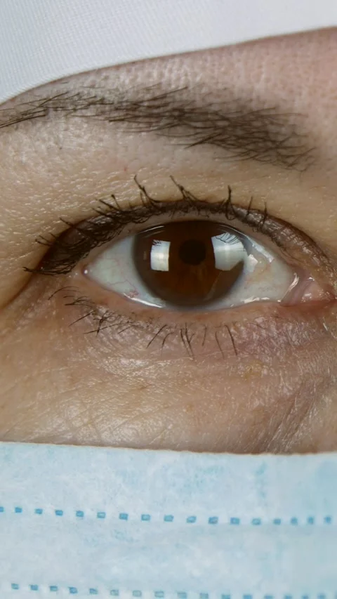 Female doctor looking at the camera. face of a woman in a medical protective Stock Footage 301293654