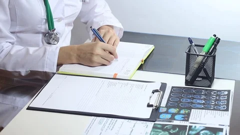 Female doctor making notes in a notebook Stock Footage 86690547