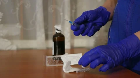 Female doctor picking up medication into a syringe Stock Footage 86536341