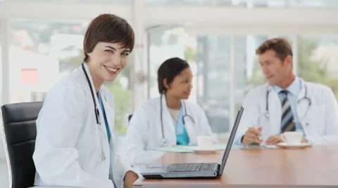 Female Doctor Posing while working on her Laptop Видео 892654