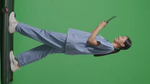 Female Doctor With Stethoscope Using A Tablet While Walking On Green Screen Stock Footage 249624717