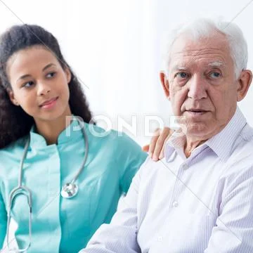 Female doctor supporting senior man Stock Photos