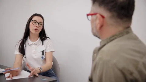 Female doctor talking while explaining medical treatment to patient Stock Footage 270914337