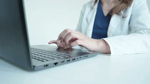 Female doctor typing on computer Stock Footage 142902464