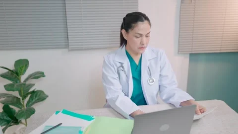 Female doctor using computer working at clinic or hospital Doctor typing on comp Stock Footage 264110800
