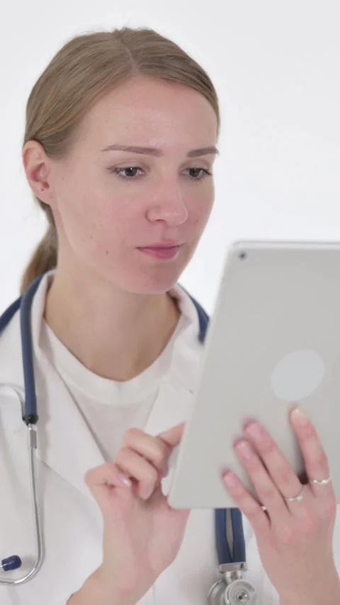 Female Doctor using Digital Tablet on White Background, Vertical Video Stock Footage 340039998