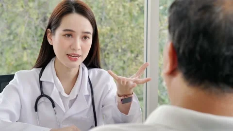 A female doctor is using hands to explain information to a male patient. Stock Footage 153853397