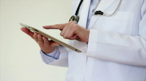 Female doctor using tablet computer in medical clinic Stock Footage 53881178