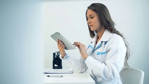 Female doctor using tablet computer in medical office Stock Footage 75208847
