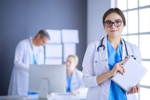 Female doctor using tablet computer in hospital lobby Stock Photos