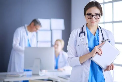 Female doctor using tablet computer in hospital lobby Stock Photos