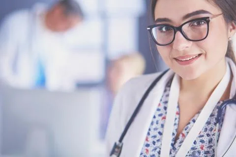 Female doctor using tablet computer in hospital lobby Stock Photos
