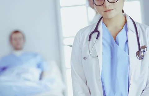 Female doctor using tablet computer in hospital lobby Stock Photos