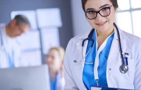 Female doctor using tablet computer in hospital lobby Stock Photos