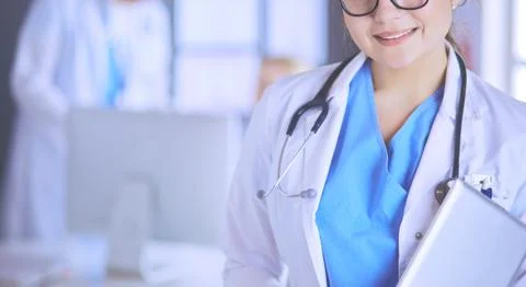 Female doctor using tablet computer in hospital lobby Stock Photos