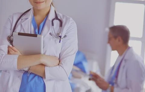 Female doctor using tablet computer in hospital lobby Stock Photos