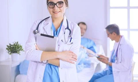 Female doctor using tablet computer in hospital lobby Stock Photos