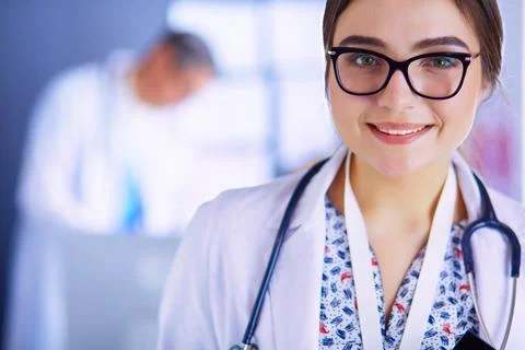 Female doctor using tablet computer in hospital lobby Stock Photos