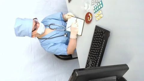 Female doctor at work working on a computer Stock Footage 128926428