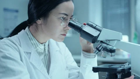 Female Doctor Working with Compound Microscope in Medical Laboratory Video stock 275495981
