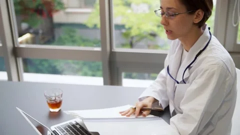Female doctor working on a computer (conversation) Stock Footage 147600109