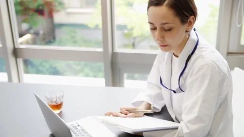 Female doctor working on a computer (conversation) Stock Footage 147600255