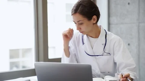 Female doctor working on a computer Stock Footage 147600047