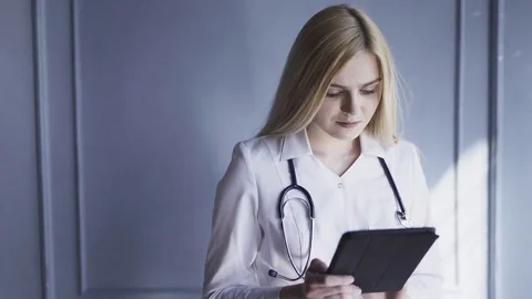 Female doctor working on tablet computer Stock Footage 75698549