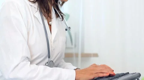 Female doctor writing on clipboard and smiling Stock Footage