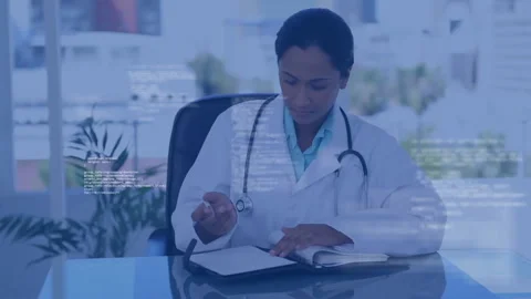 Female doctor writing notes on glass-top desk inside medical office, with Stock Footage 307466853