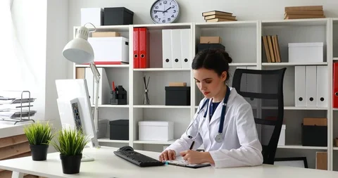 Female doctors comparing data in documents. Stock Footage 91339399