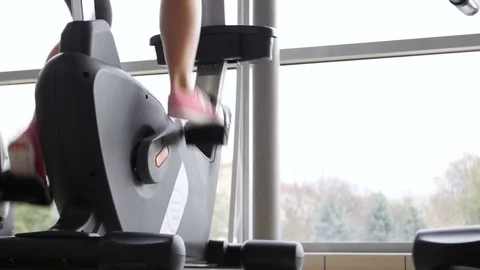 Female doing cardio workout on cycle at gym. Stock Footage 81840553