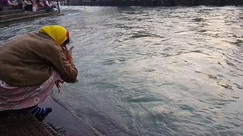 A Female Doing Deep Daan On Ganga Ghat, Haridwar India Stock Footage 111817840