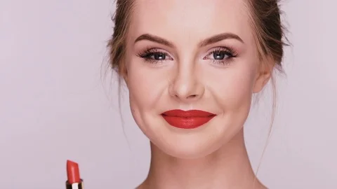 Female doing make-up on grey background Stock Footage 110207727